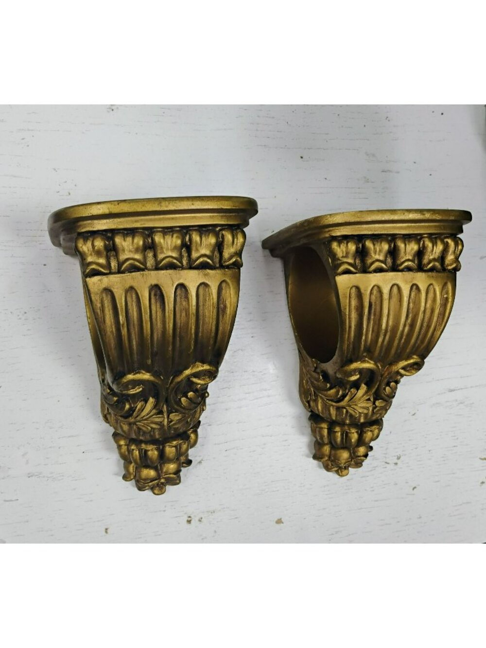Pair Of Gold Tone Drapery Sconces With Ornate Floral Design